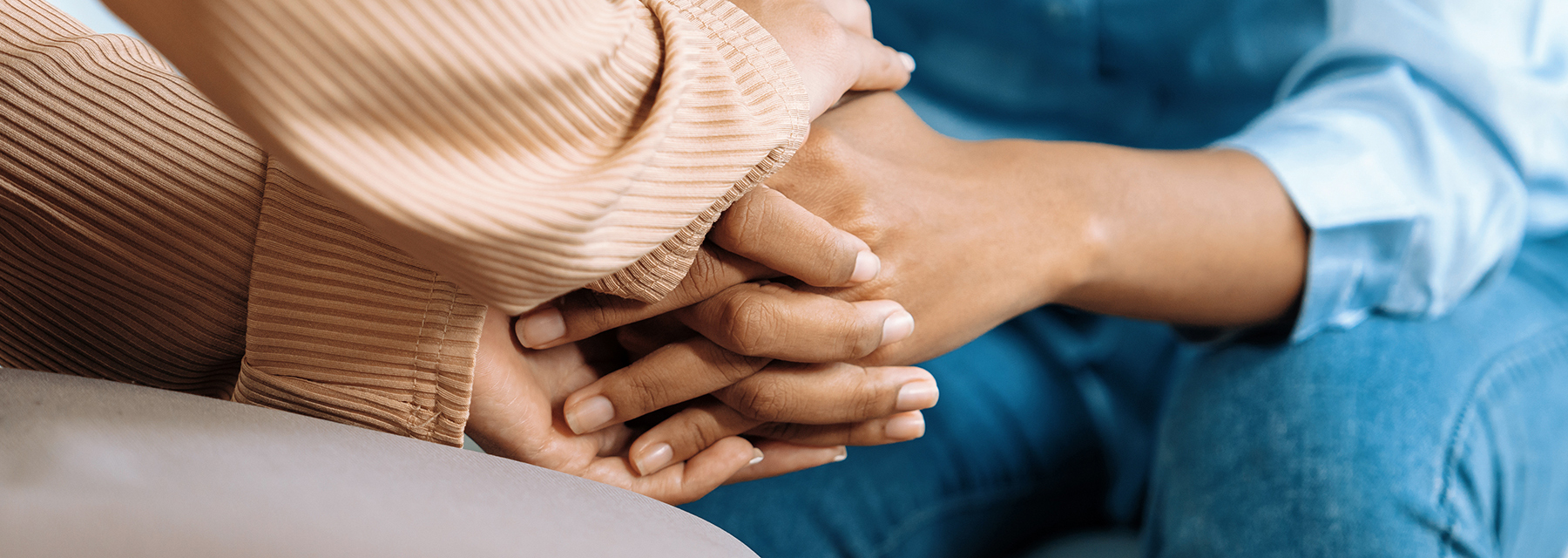 two people holding hands in comfort